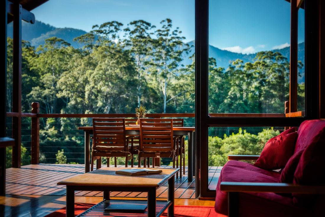 The main living area looking out over the deck to the mountains